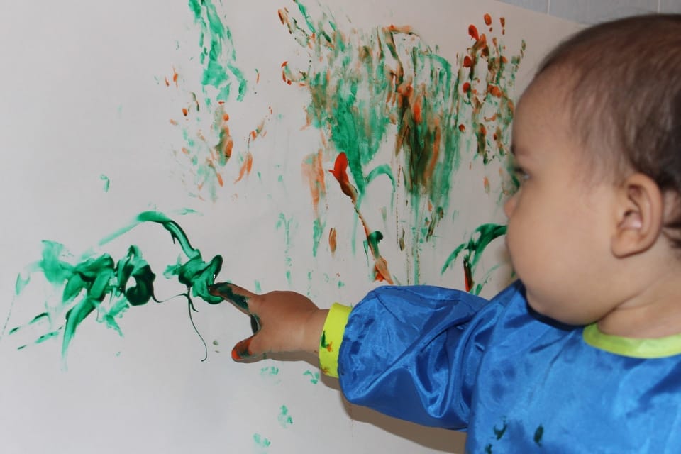 A toddler fingerpainting.